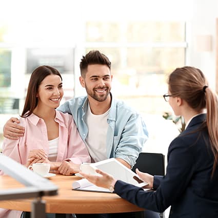 Young Couple Talking With Insurance Agent